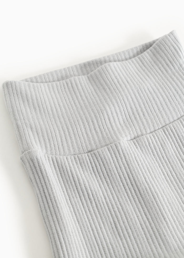 Ribbed baby pants with elastic waistband and visible rib stitching.