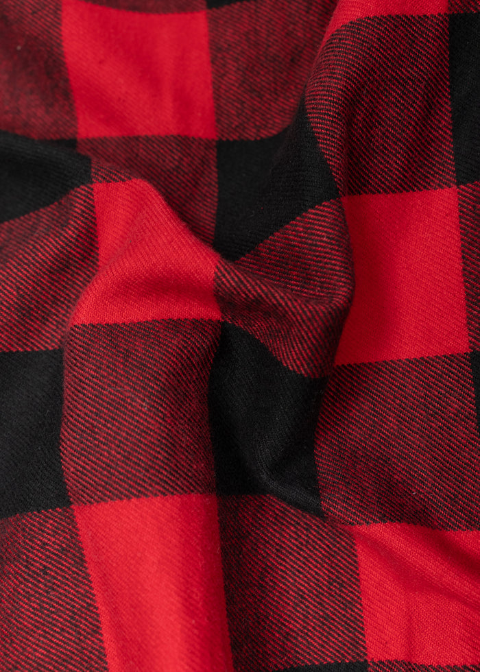 Red and black plaid fabric with a checkered pattern, slightly wrinkled, creating a textured appearance.