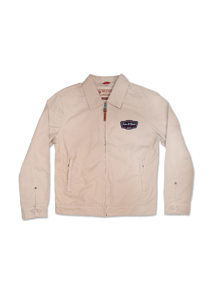Beige zip-up jacket with collar, patch logo on chest, and buttoned cuffs, laid flat on a white background.