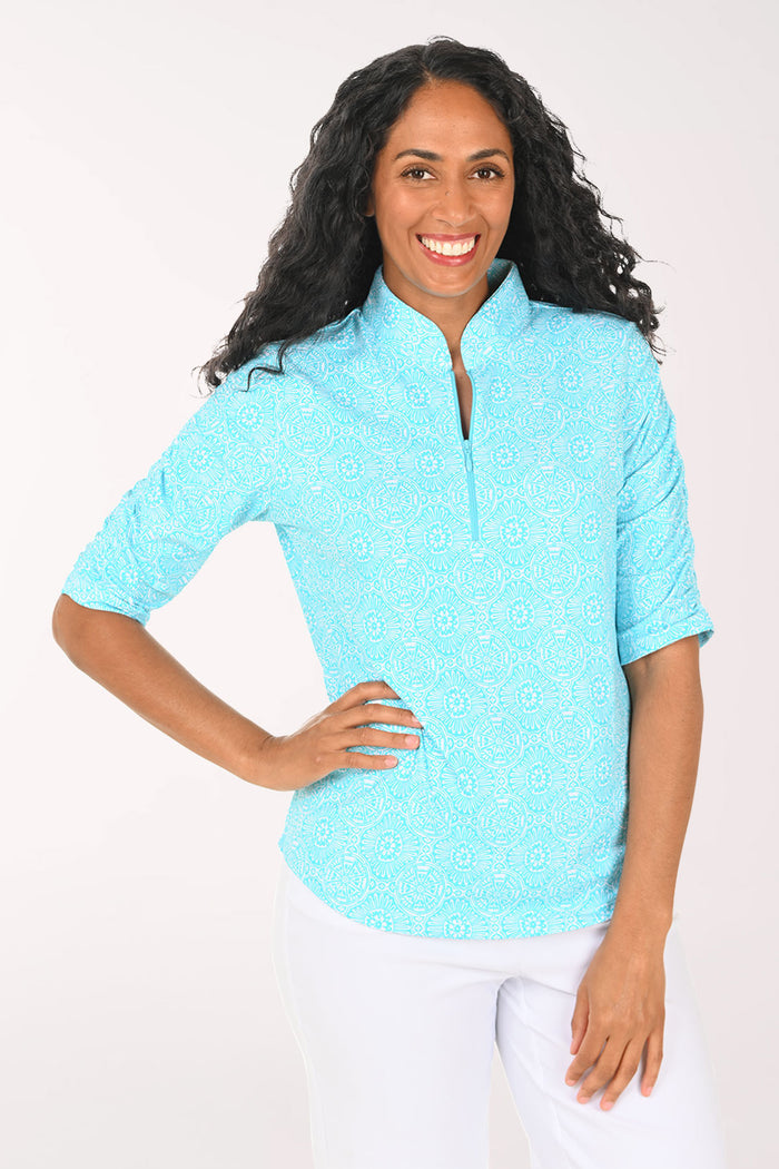 Woman wearing a light blue short-sleeve shirt with a white background
