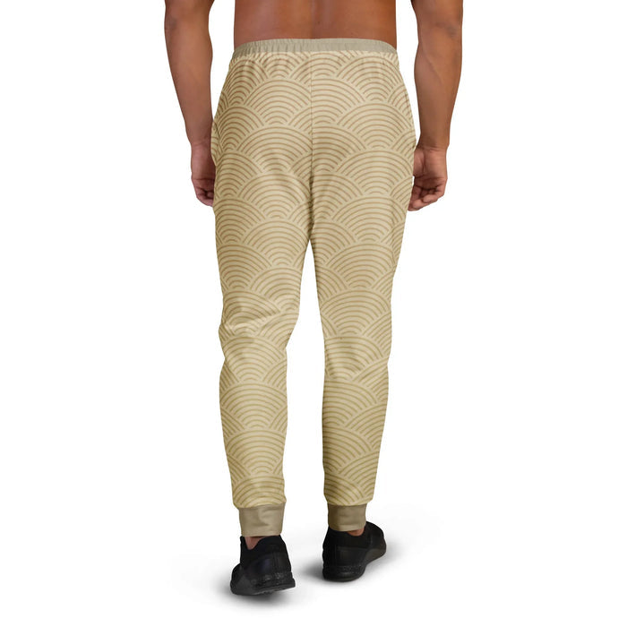 Street Catfish Joggers - The hypnotic repetition of **concentric semi-circles (Seigaiha)** rendered in **sandy beige (#E3D1AC)** and **earthy taupe (#9F8C68)** mimicking fish scales.