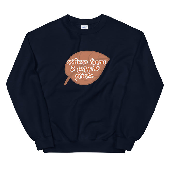 The Sassy Woof "Autumn Leaves & Puppies Please" sweatshirt is black with a brown leaf graphic and white and orange text—perfect for cozy cuddles and all your favorite fall activities.