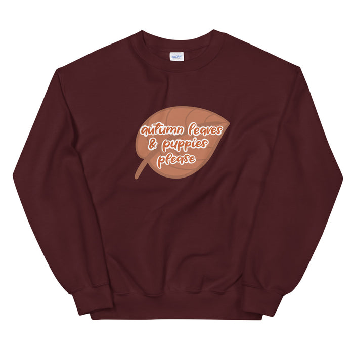 The Sassy Woof "Autumn Leaves & Puppies Please" sweatshirt features playful script and a brown leaf design on maroon—perfect for cozy fall days with your pup.