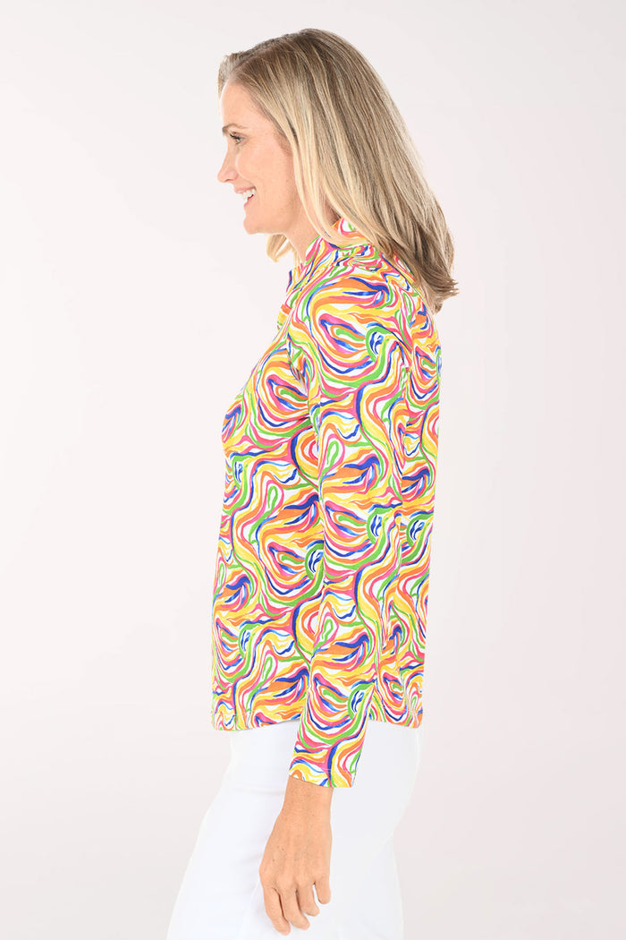 Woman wearing a colorful patterned shirt on a white background