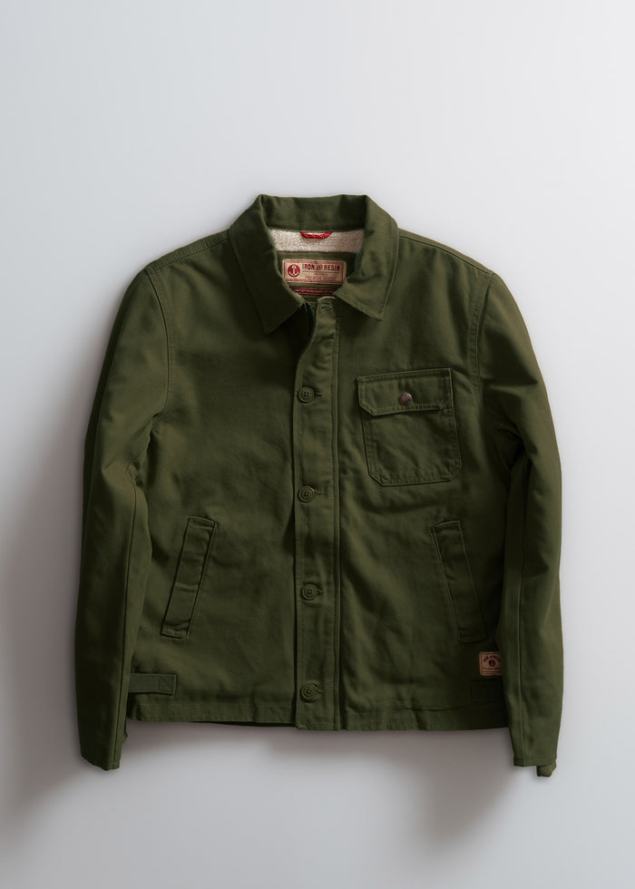 Olive green jacket with button closure, chest pocket, and collar, displayed on a white background. Iron & Resin label inside.