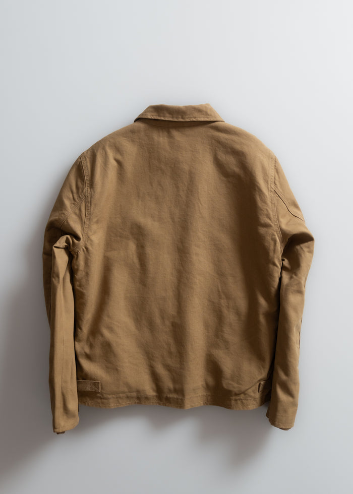 Brown jacket displayed on a white wall, viewed from the back, highlighting its simple design and long sleeves.