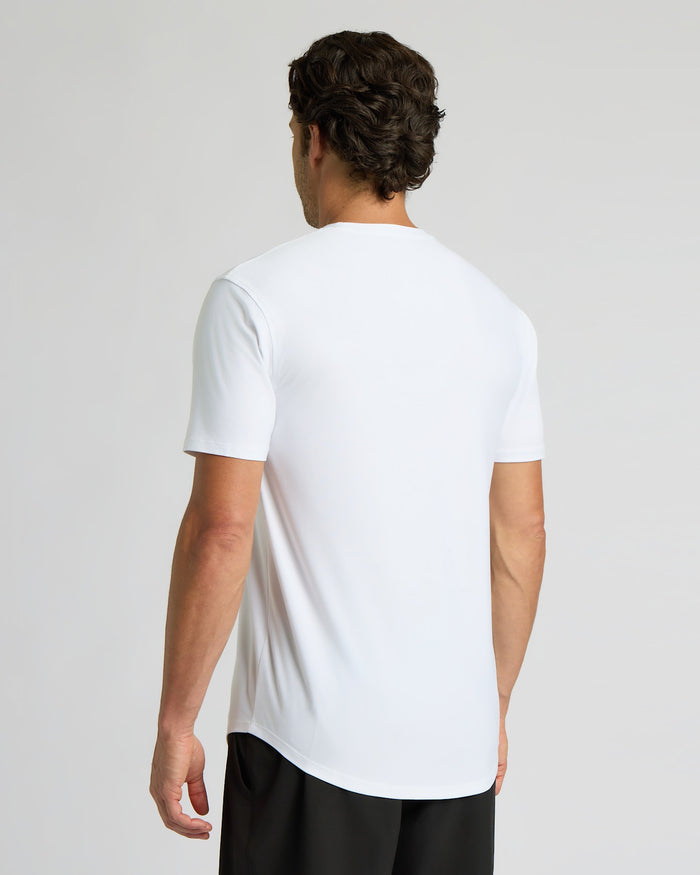 Man wearing a white t-shirt on a plain background