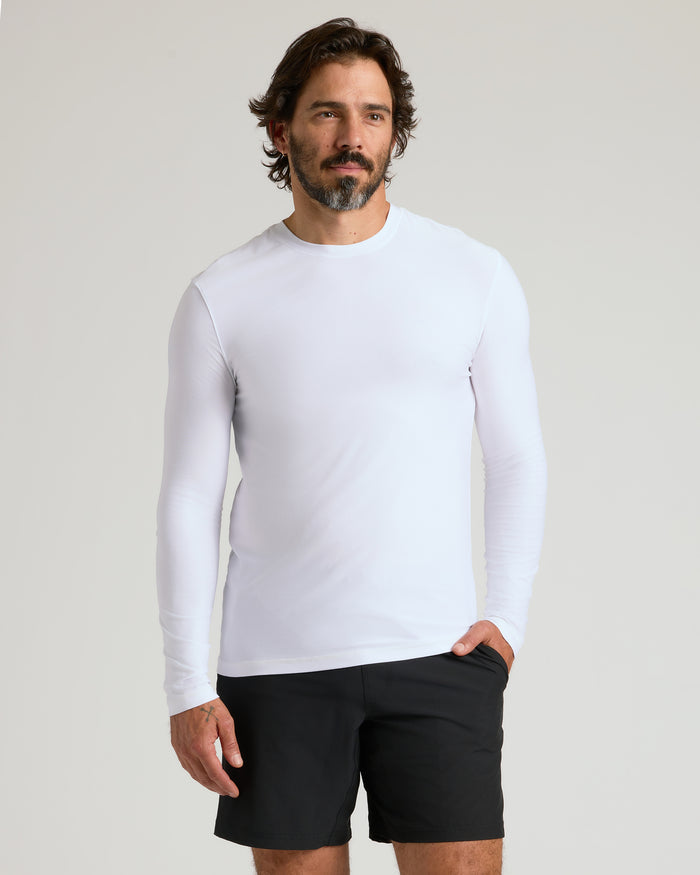 Man wearing White Active Long Sleeve Crew T-Shirt with black shorts.