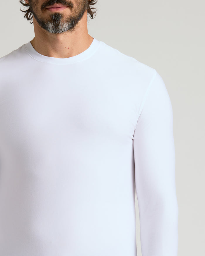 Man wearing White Active Long Sleeve Crew T-Shirt, light-gray background.