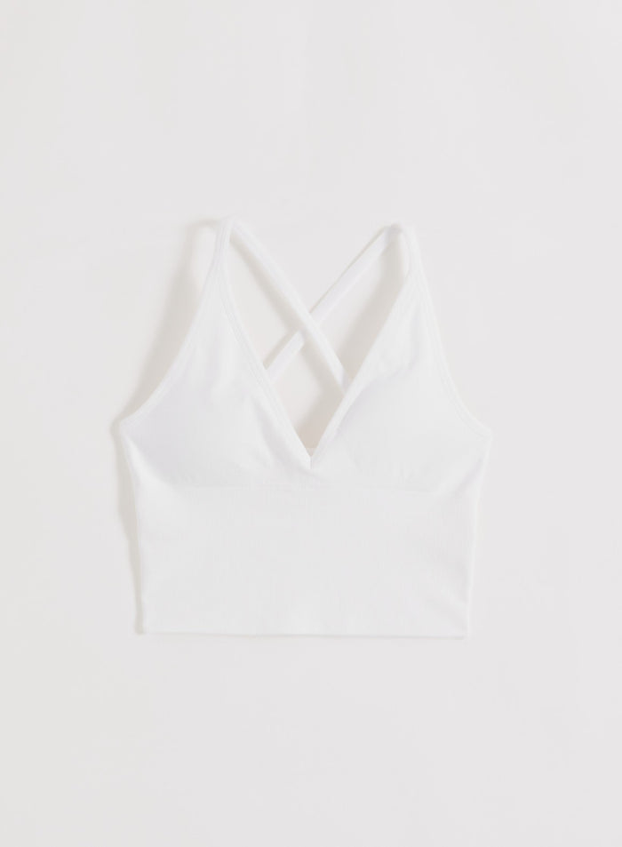White aim'n Shape Seamless Cross Back Bralette with ribbed contouring and a strappy V-neck design.