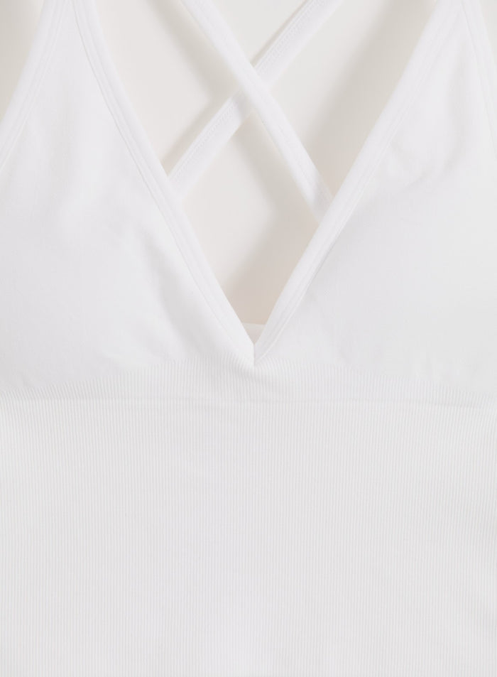 White aim'n Shape Seamless Cross Back Bralette with ribbed details and a deep V-neck.