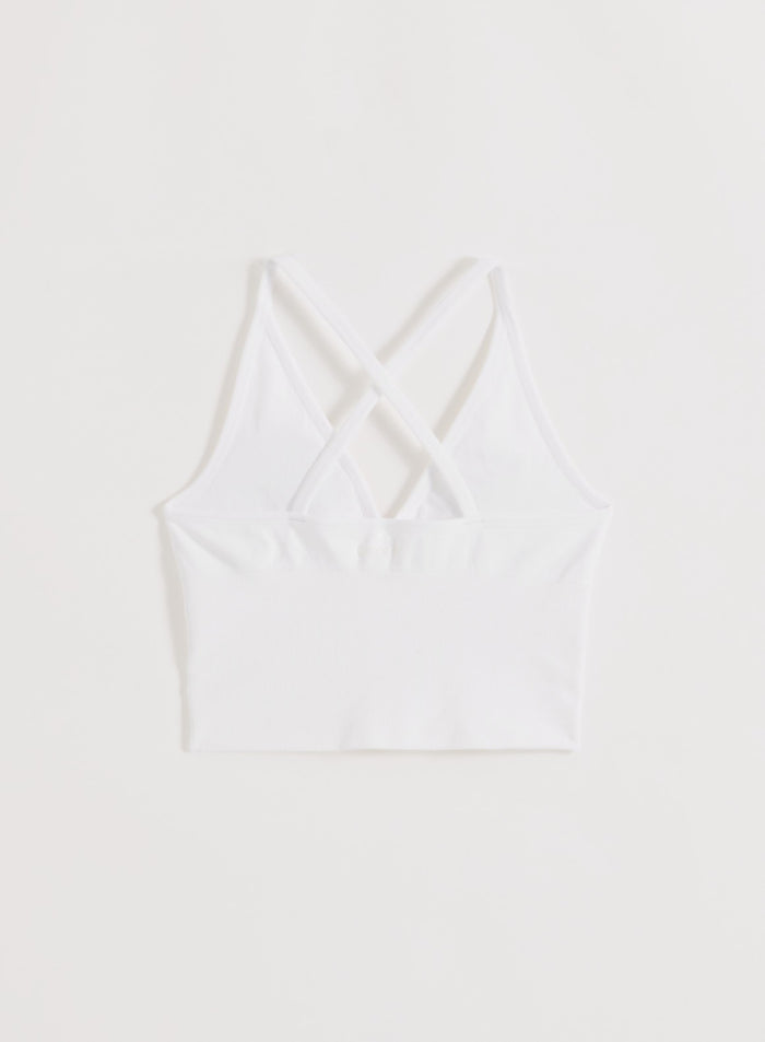 White aim'n Shape Seamless Cross Back Bralette featuring a strappy back and ribbed texture.