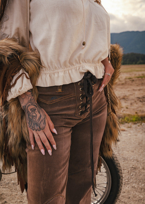 Person wearing a fur coat and brown pants with a scenic background wearing Soul Sister since 1969